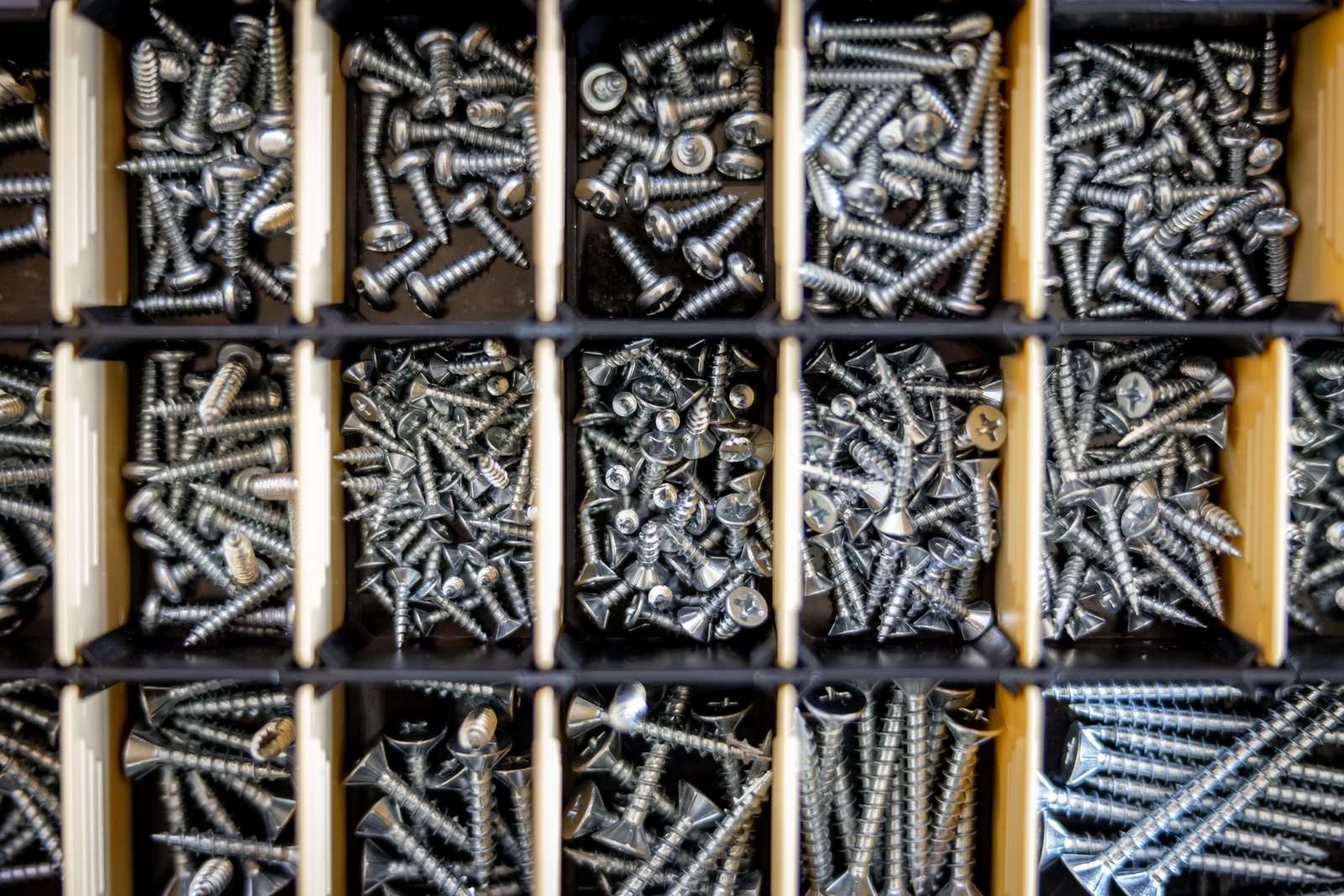 Consumibles industriales: tornillería y fijaciones surtidas en organizador.